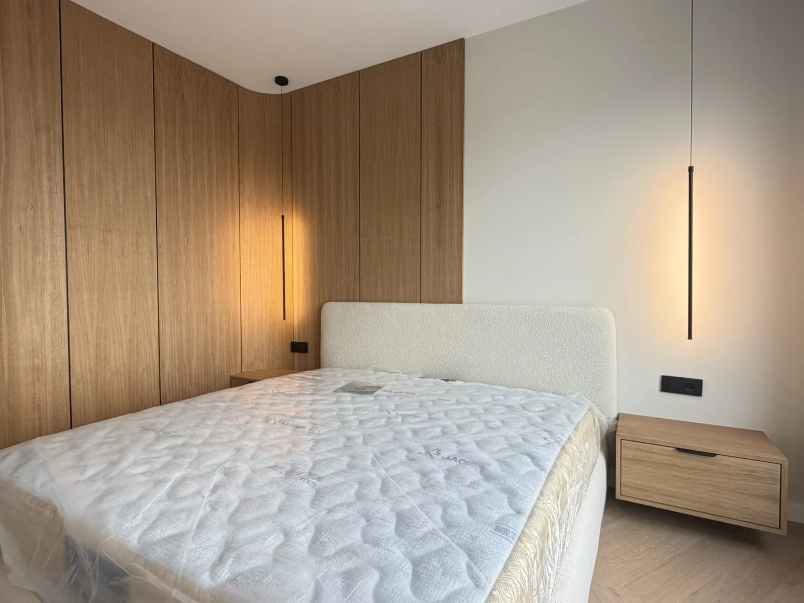 Completed bedroom with warm timber finishes and bespoke furniture